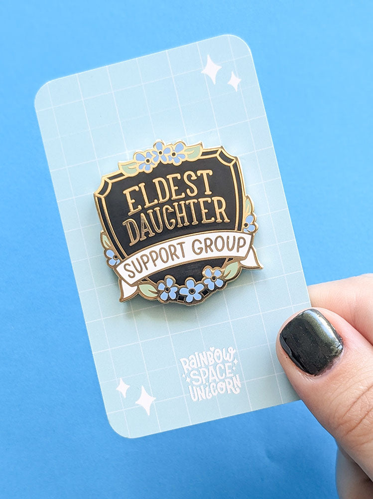 Eldest Daughter Support Group enamel pin on backing card